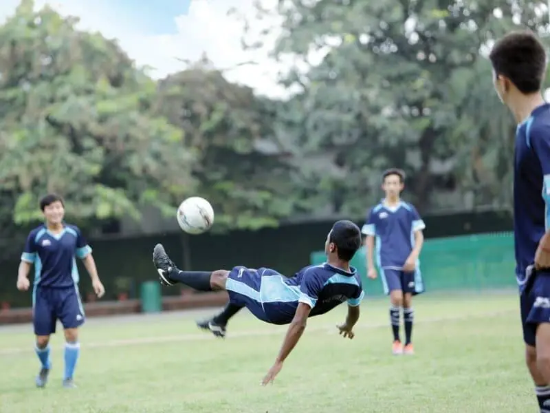 The-Asian-School-Students-playing-football